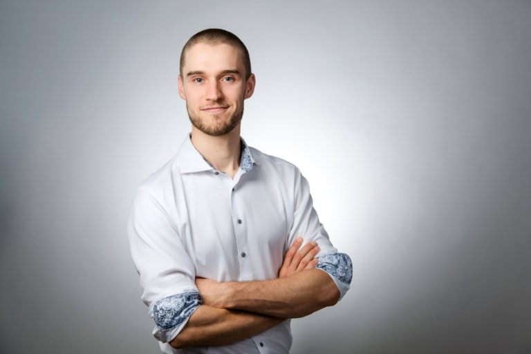 Confident man in a white shirt with rolled-up sleeves.