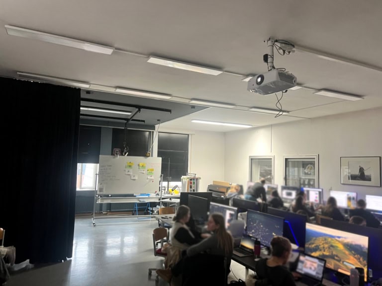 1. Modern room with multiple computers and learners, ideal for professional training and workshops.